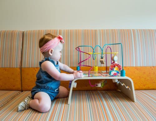 Toddler playing with a toy in Pediatric Associates of Dallas waiting area