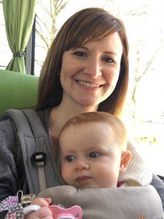 Dr. Waters wears her daughter, Mallory, in a baby carrier