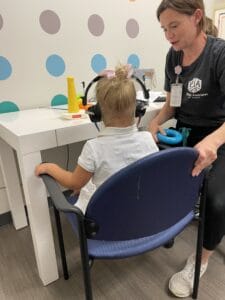 Child receiving a hearing assessment from an audiologist at Pediatric Associates of Dallas