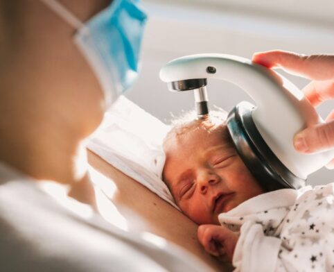 Newborn receiving hearing screening test in hospital