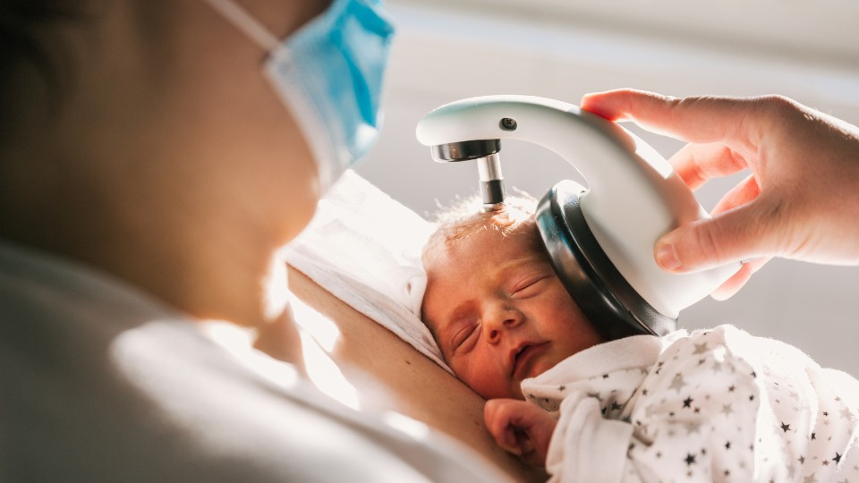 Newborn receiving hearing screening test in hospital