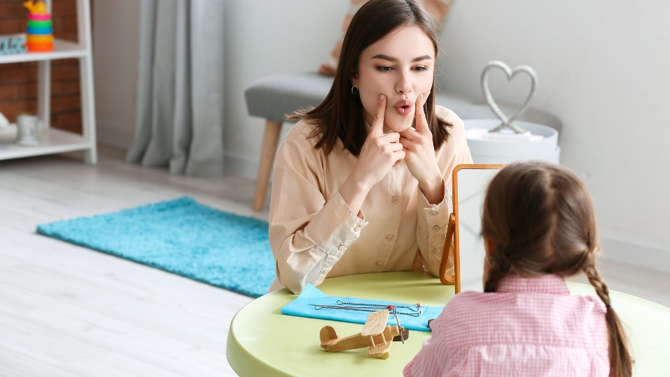 Interactive feeding therapy session with a child and therapist emphasizing oral motor skills