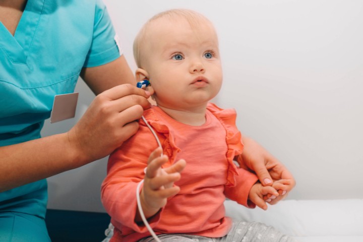 Hearing evaluation for a baby conducted by a professional audiologist