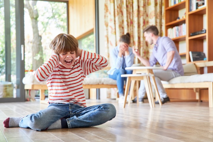 A child experiencing emotional distress at home, highlighting the need for behavioral therapy