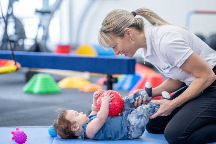 Pediatric physical therapist in Dallas working with an infant on motor skills