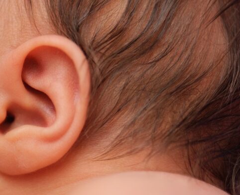 Close-up view of a newborn’s ear highlighting auditory health