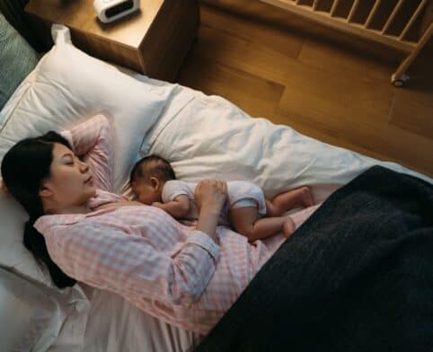 Mother and baby in comfortable side-lying position for night breastfeeding