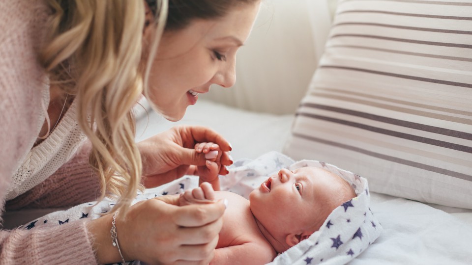Parent using baby-directed speech to support speech development in a newborn with hearing loss