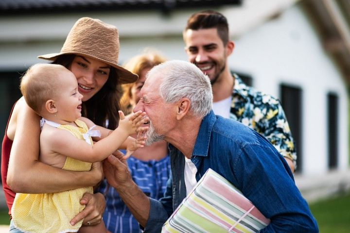 A multi-generational family bonding outdoors, emphasizing how hearing health supports strong relationships