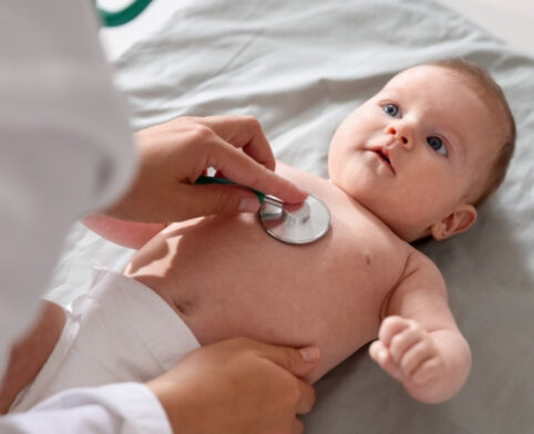 Pediatrician assessing infant lung function to determine if the baby would require further infant pulmonary function testing