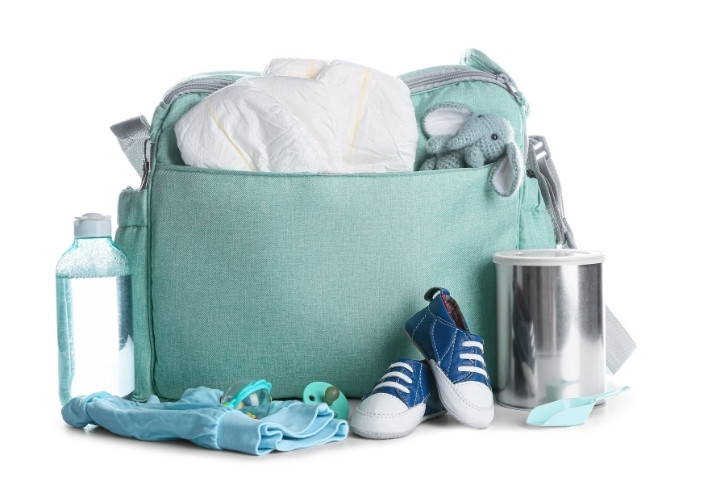 Items to pack for a pediatric appointment including diapers, bottle, and comfort toy