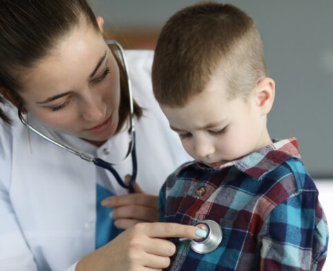 Pediatrician examining a child during a children’s medical clinic visit