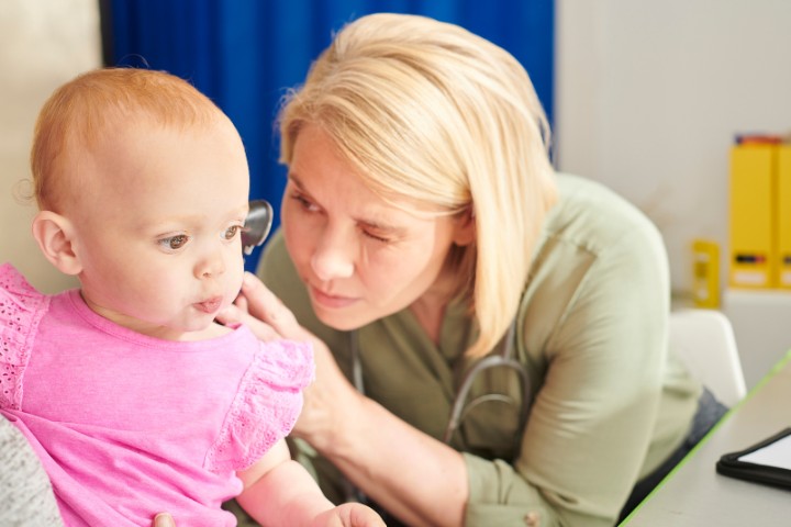 Pediatrician checking baby’s ear infection