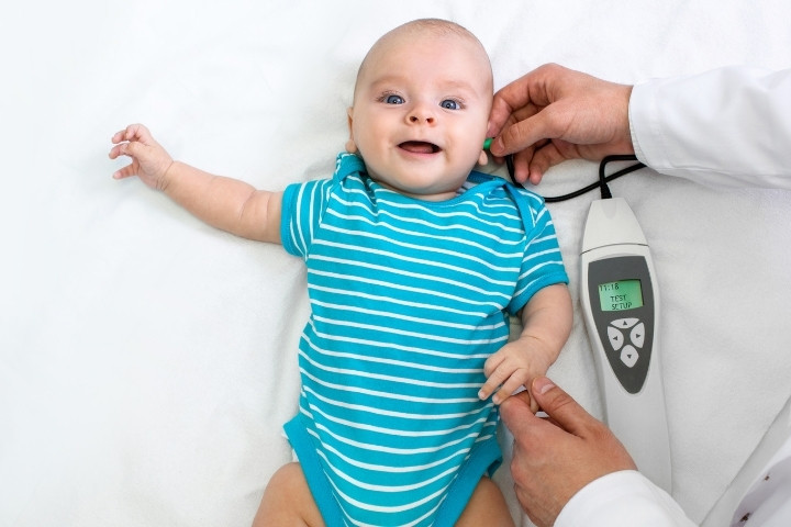 Infant undergoing a pediatric hearing screening