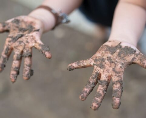 Dirty child hands from playground activity and outdoor play
